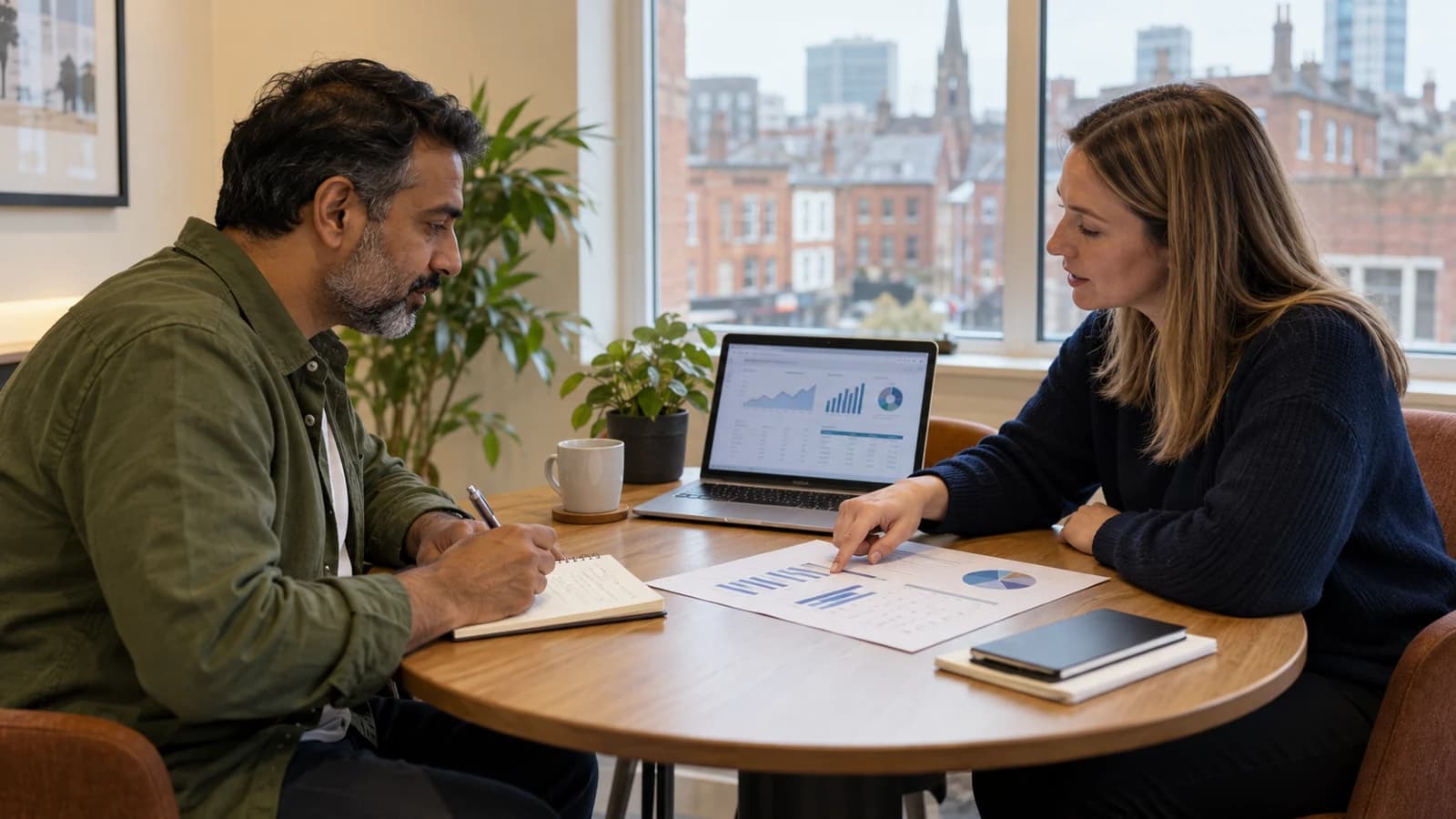 Marketing professionals reviewing campaign analytics and performance charts at a table